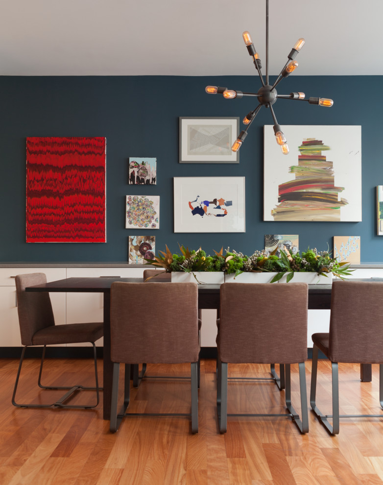 Mid-sized trendy light wood floor enclosed dining room photo in New York with blue walls and no fireplace