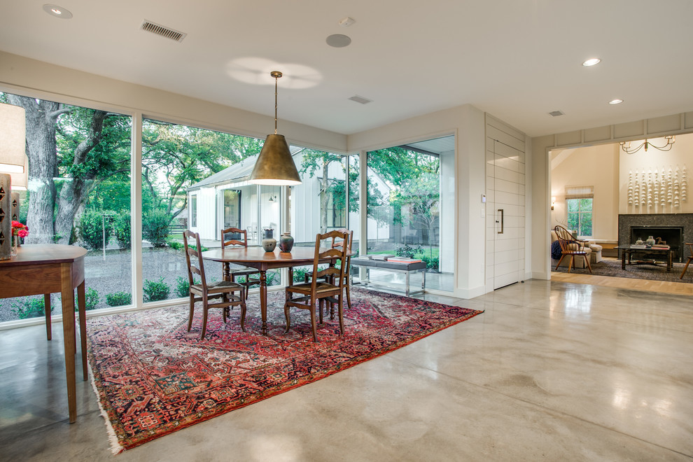 Large rural dining room in Dallas with concrete flooring.