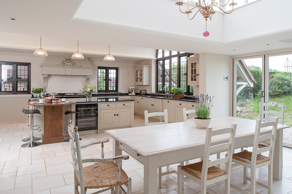 Inspiration for a large classic kitchen/dining room in Kent with white walls, limestone flooring and beige floors.