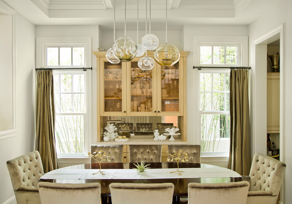 This is an example of a traditional dining room in Los Angeles with white walls.