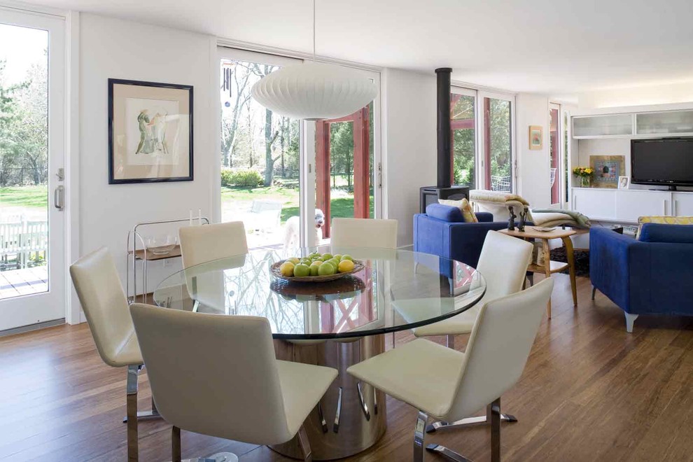 Design ideas for a modern open plan dining room in New York with medium hardwood flooring.