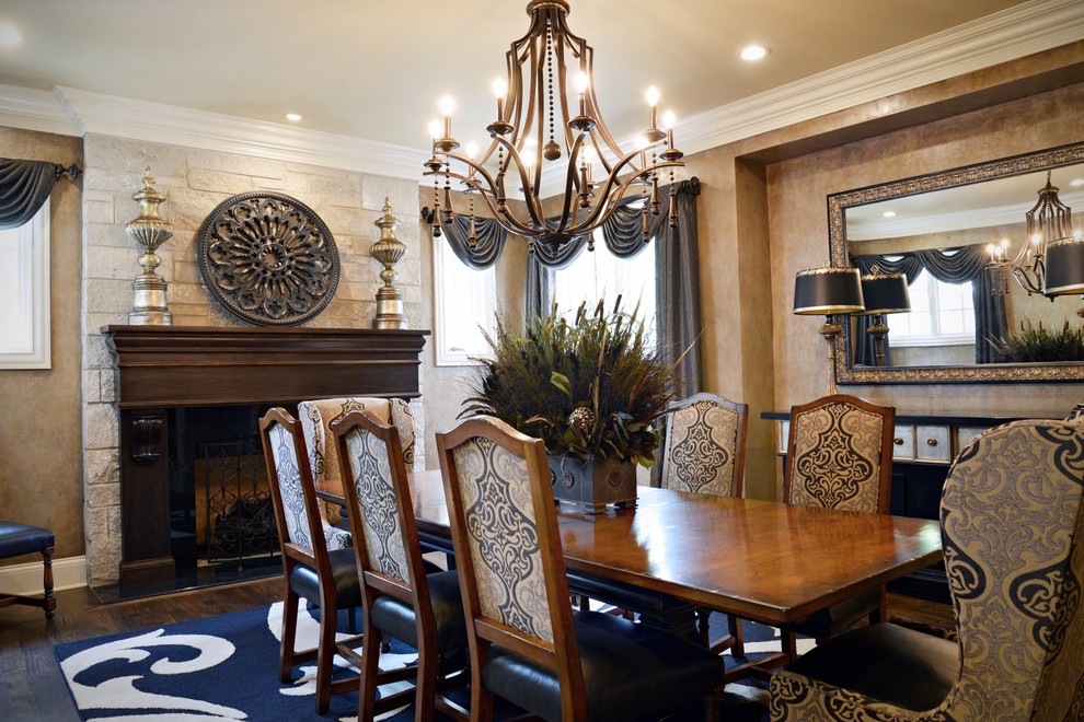 Photo of a medium sized traditional enclosed dining room in St Louis with brown walls, medium hardwood flooring, a standard fireplace, a wooden fireplace surround and brown floors.