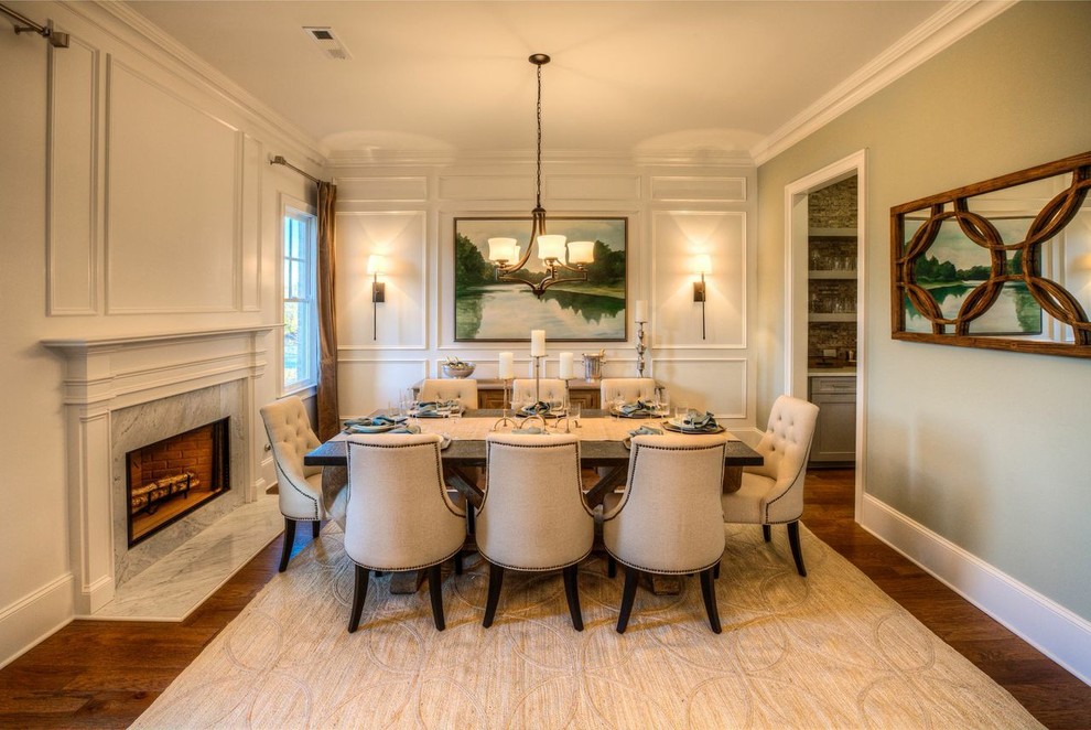 Inspiration for a large timeless dark wood floor enclosed dining room remodel in Atlanta with beige walls and a standard fireplace