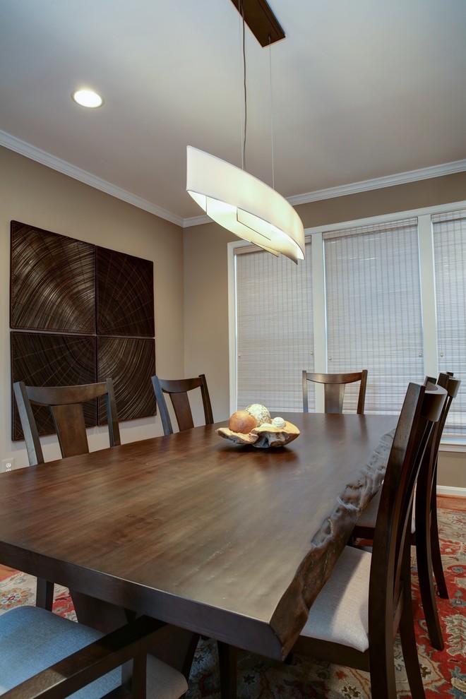 This is an example of a medium sized world-inspired enclosed dining room in DC Metro with beige walls, medium hardwood flooring, no fireplace and brown floors.