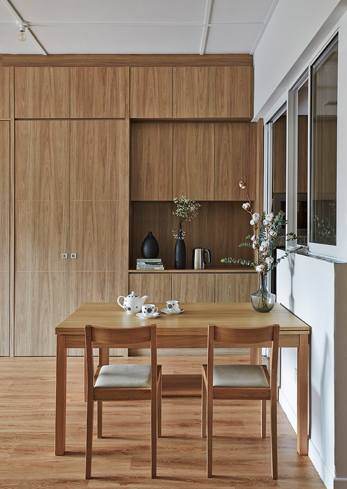 Immagine di una sala da pranzo minimal con pareti bianche, pavimento in legno massello medio e pavimento marrone