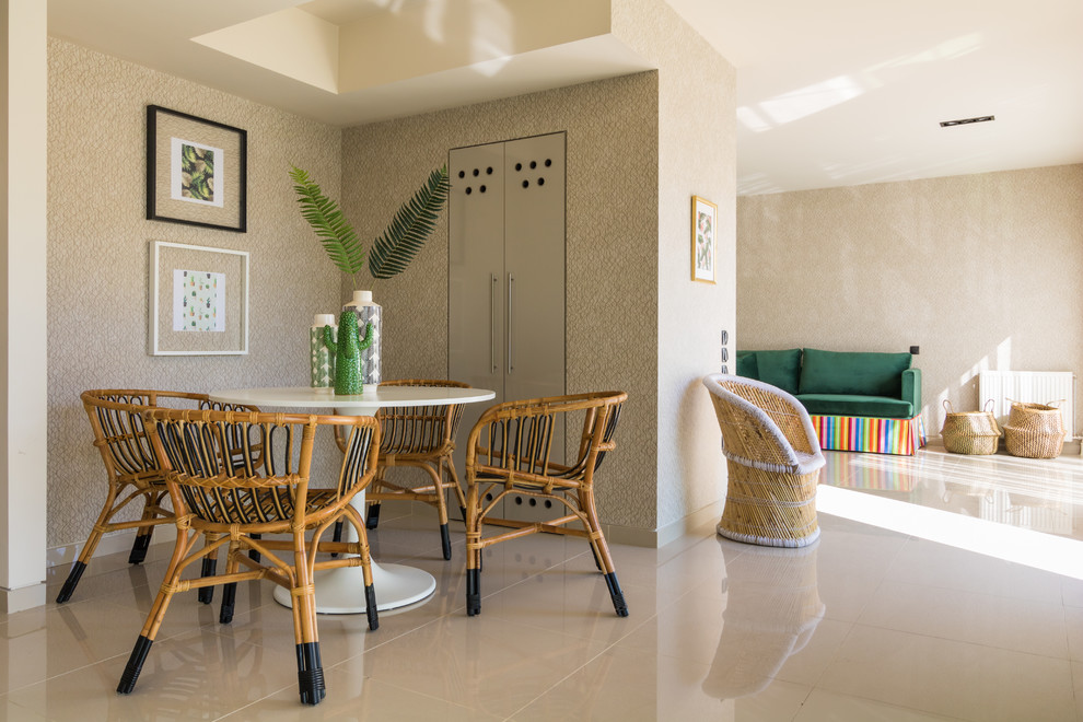 Esempio di una sala da pranzo aperta verso il soggiorno tropicale con pareti beige e pavimento beige