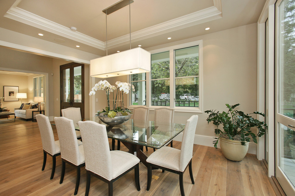 Inspiration for a traditional dining room in San Francisco with beige walls and feature lighting.