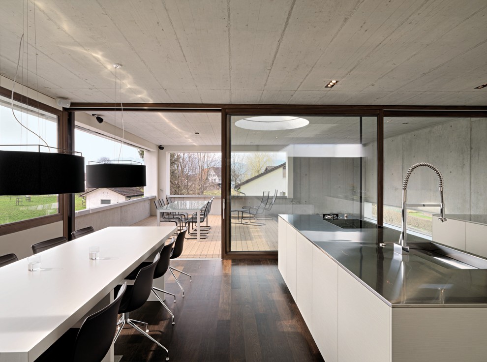 Example of a minimalist dark wood floor kitchen/dining room combo design in New York