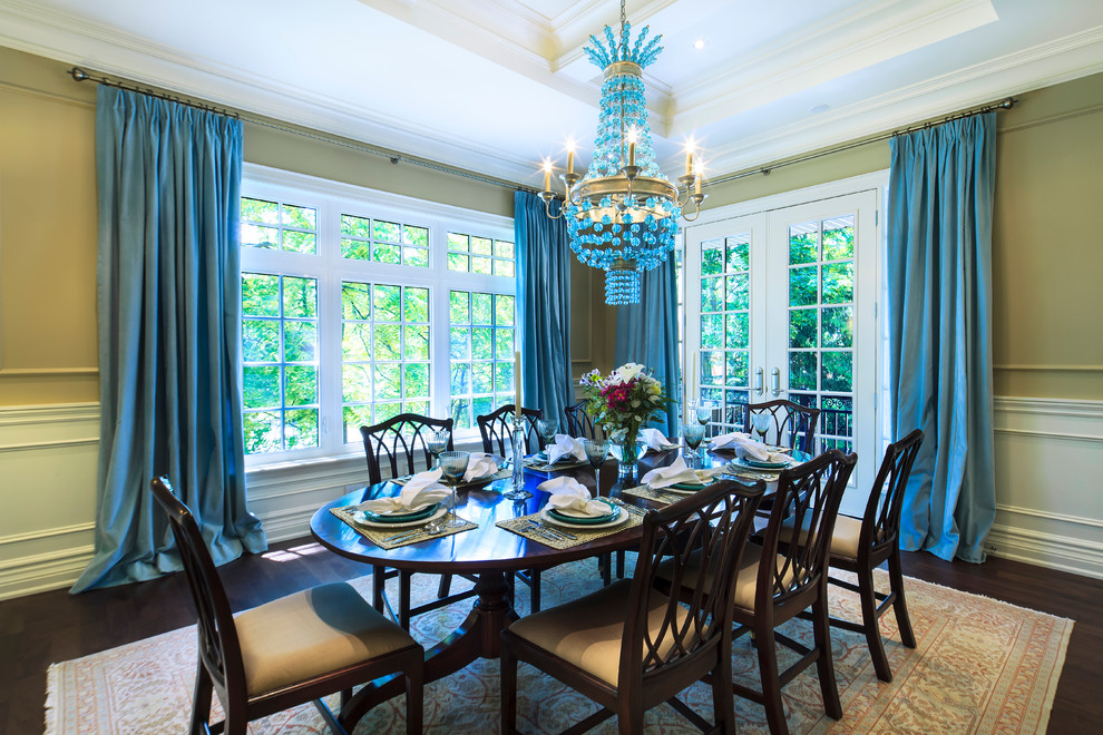 Traditional dining room in Toronto with green walls and dark hardwood flooring.