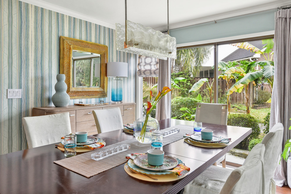 Inspiration for a medium sized eclectic enclosed dining room in Jacksonville with blue walls and wallpapered walls.