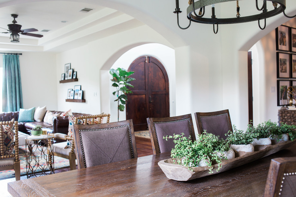 Inspiration for a medium sized mediterranean enclosed dining room in Austin with white walls, dark hardwood flooring, no fireplace and brown floors.