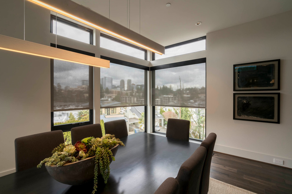 Example of a mid-sized minimalist dark wood floor and brown floor enclosed dining room design in Seattle with beige walls and no fireplace