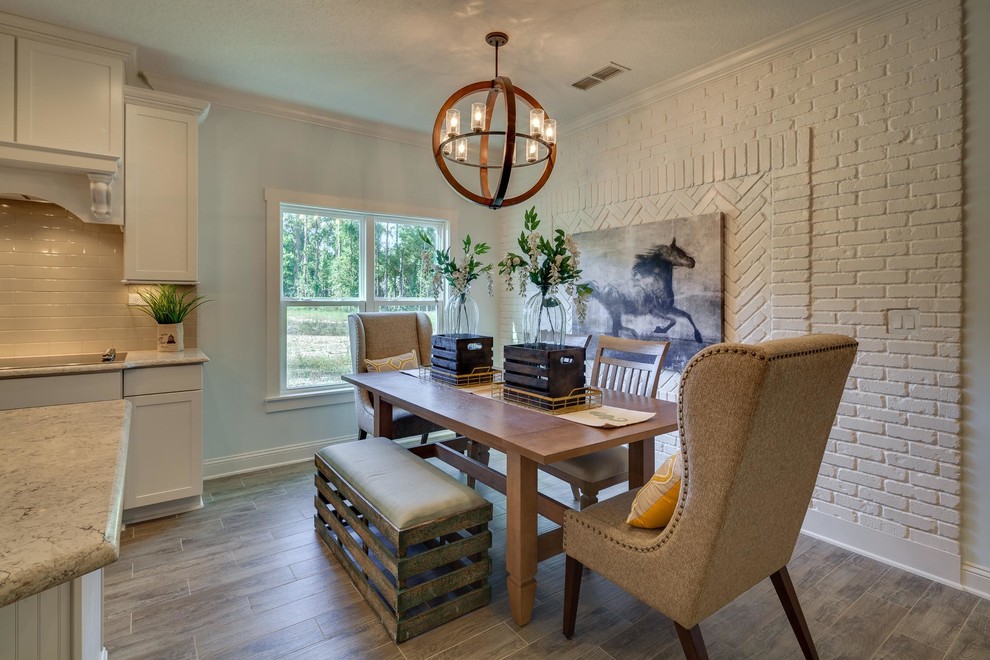 Kitchen/dining room combo - mid-sized country laminate floor kitchen/dining room combo idea in Jacksonville with white walls and no fireplace