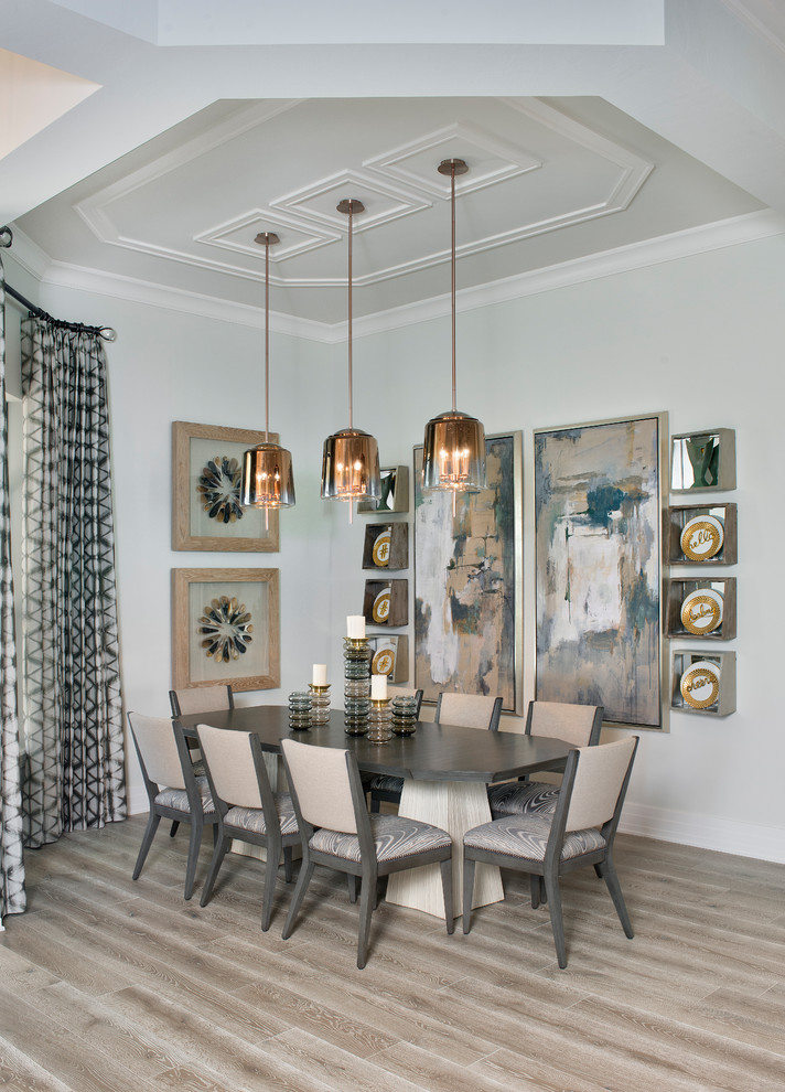 Inspiration for a traditional dining room in Miami with grey walls and beige floors.