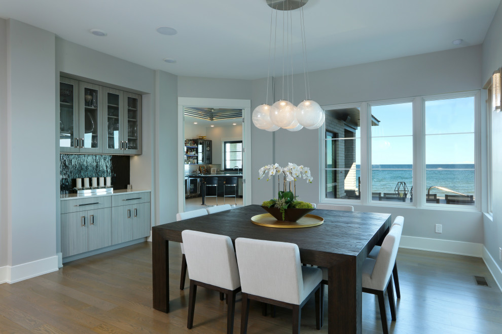 Inspiration for a large transitional medium tone wood floor kitchen/dining room combo remodel in Grand Rapids with gray walls