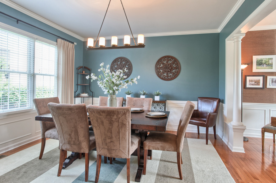 Design ideas for a traditional enclosed dining room in Orange County with blue walls and medium hardwood flooring.