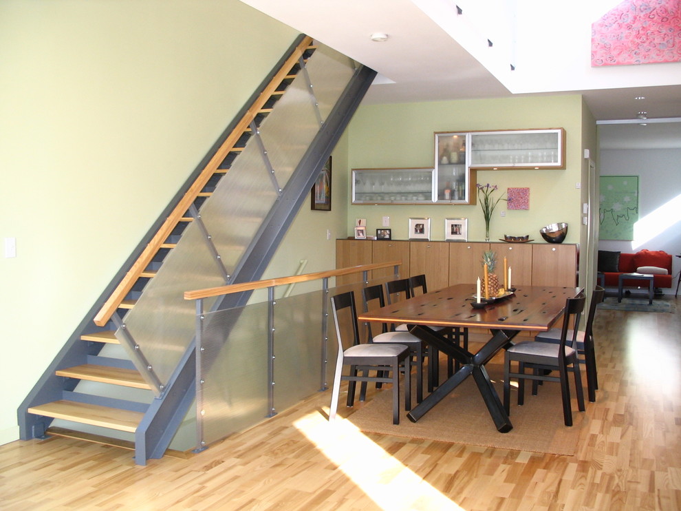 Inspiration for a modern medium tone wood floor dining room remodel in Minneapolis with green walls