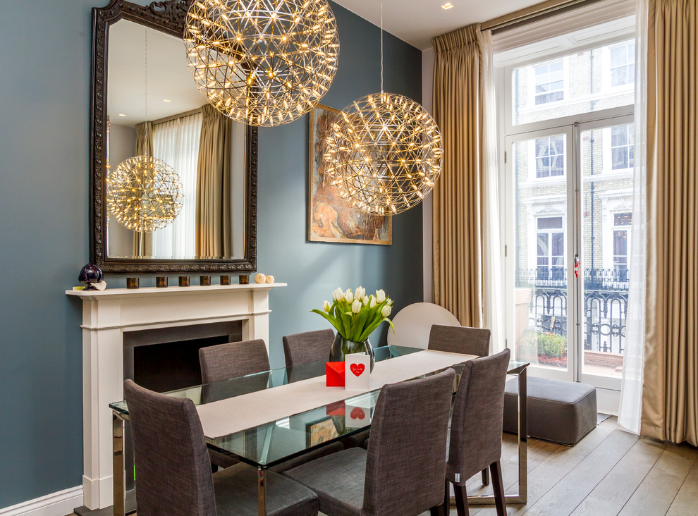 Photo of a modern dining room in London with medium hardwood flooring.