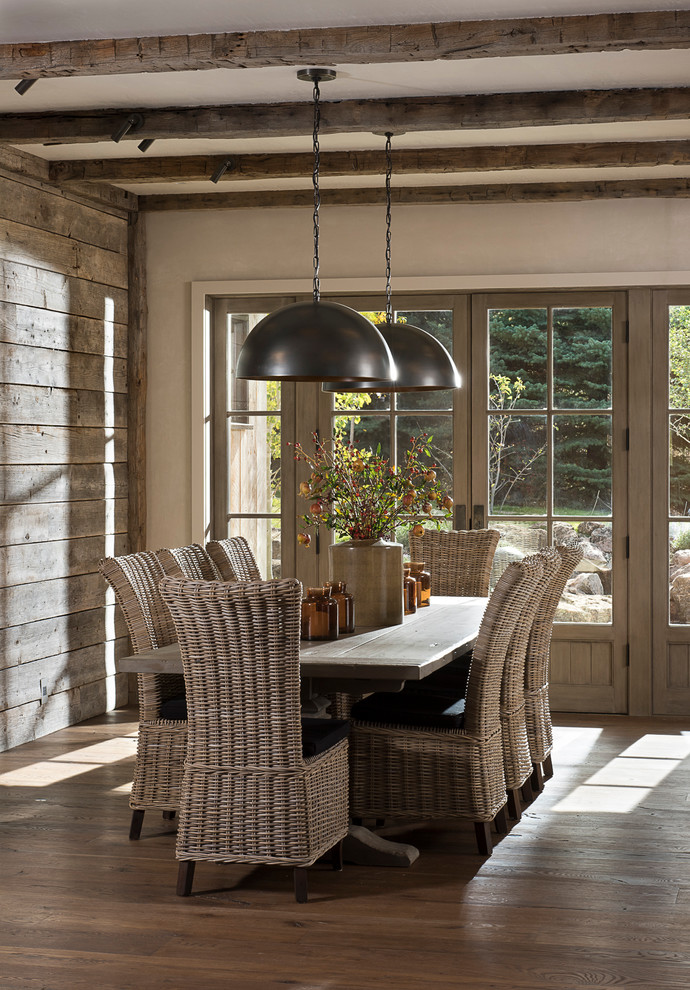 This is an example of a rustic dining room in Other with grey walls and dark hardwood flooring.