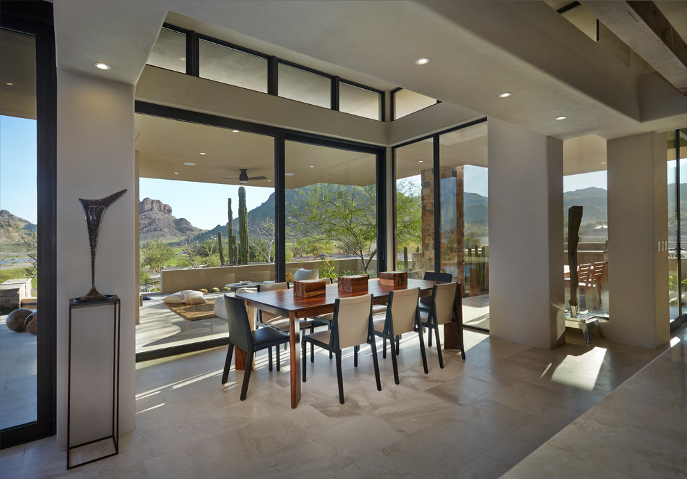Example of a large southwest limestone floor and gray floor dining room design in Other with gray walls