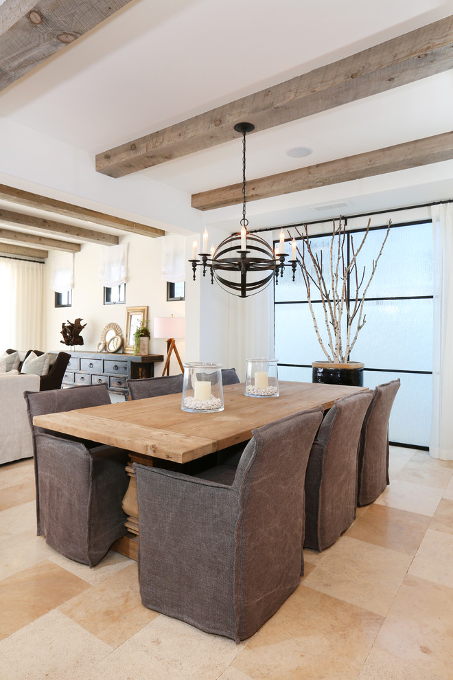 Inspiration for a beach style open plan dining room in Orange County with white walls and light hardwood flooring.