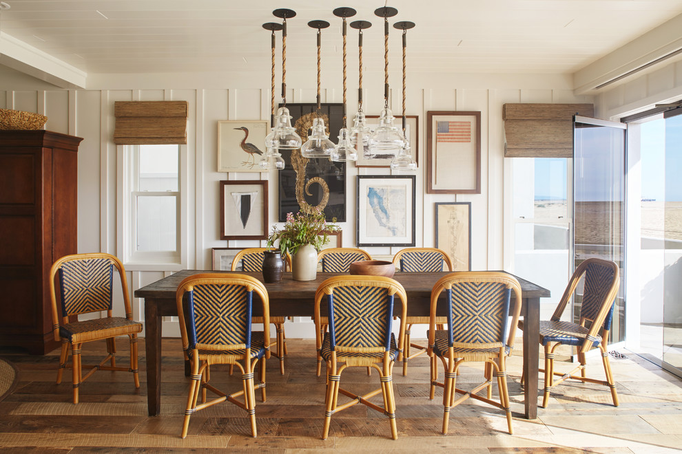 Medium sized coastal open plan dining room in Orange County with white walls and light hardwood flooring.