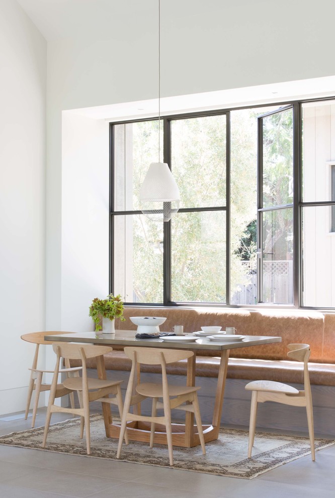Design ideas for a farmhouse dining room in San Francisco with white walls and grey floors.