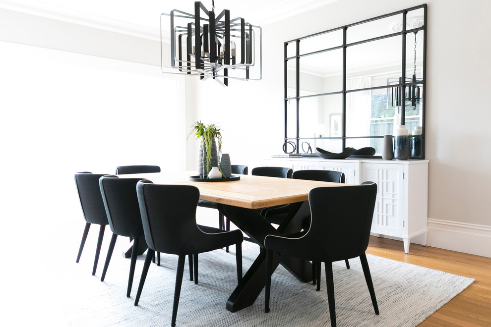Photo of a medium sized contemporary open plan dining room in Sydney with white walls and light hardwood flooring.