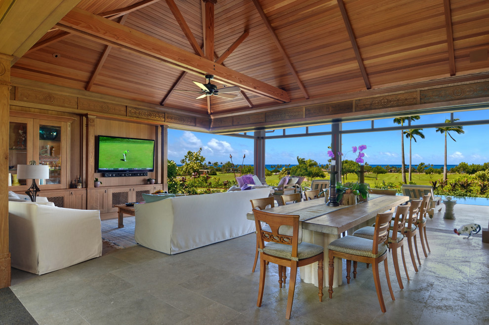 Photo of a world-inspired open plan dining room in Hawaii with feature lighting.