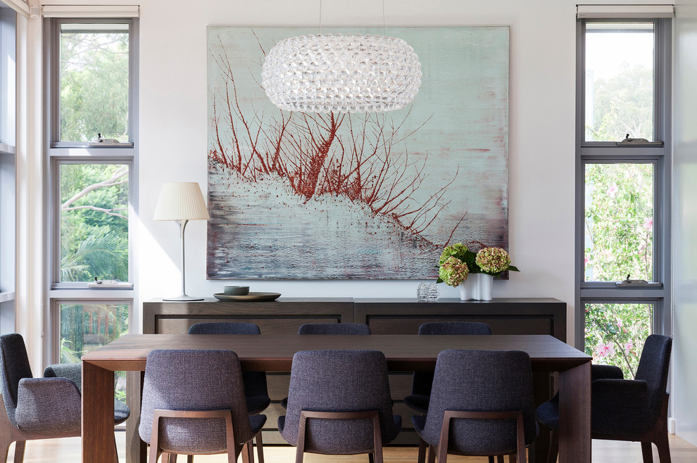 Contemporary dining room in Sydney with feature lighting.