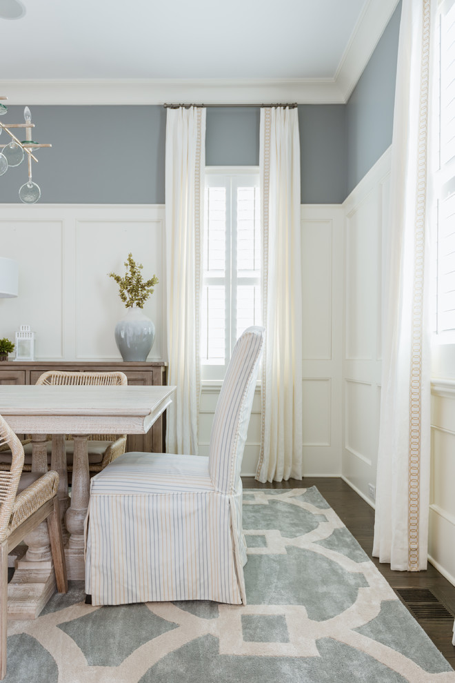 This is an example of a traditional dining room in Charlotte with blue walls.