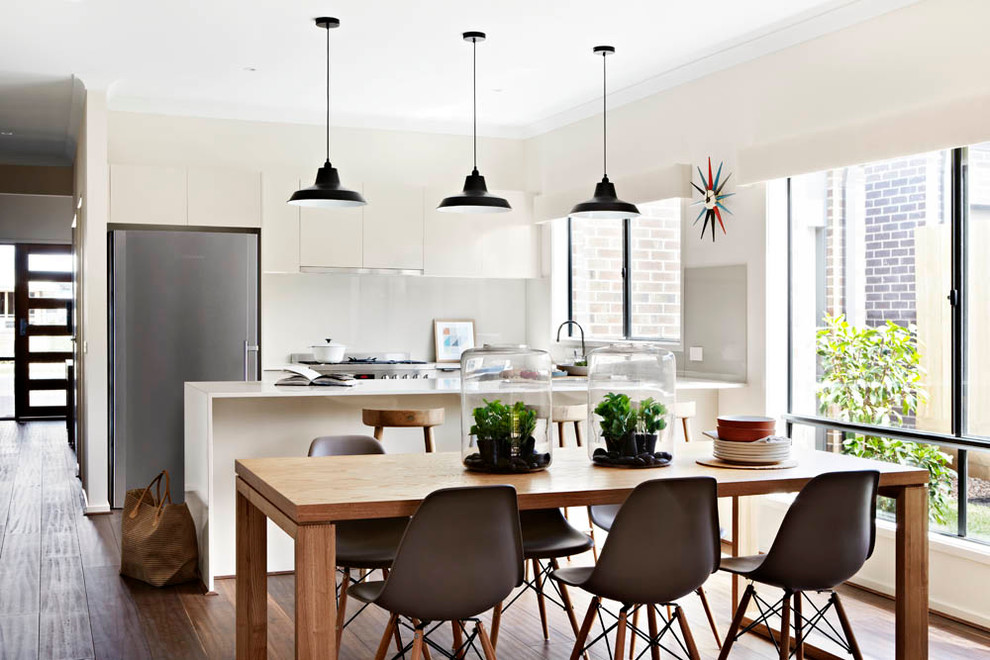 Trendy medium tone wood floor kitchen/dining room combo photo in Melbourne with beige walls and no fireplace