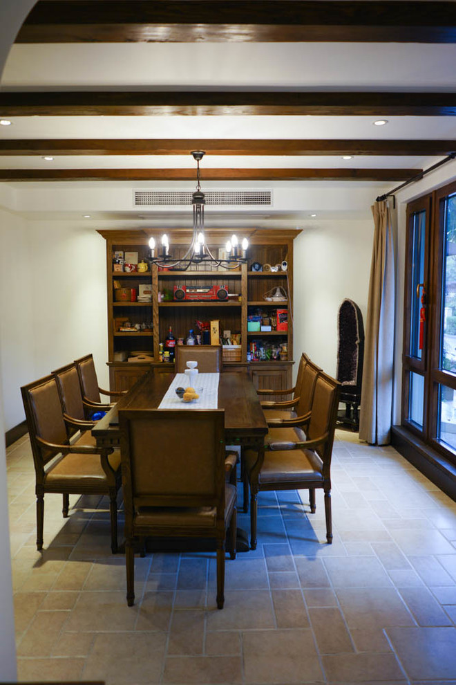Photo of a small mediterranean kitchen/dining room in Other with beige walls, brick flooring, no fireplace and beige floors.