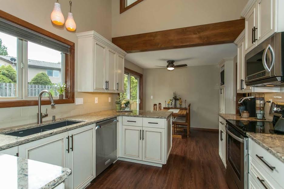 Design ideas for a medium sized farmhouse kitchen/diner in Portland with dark hardwood flooring.