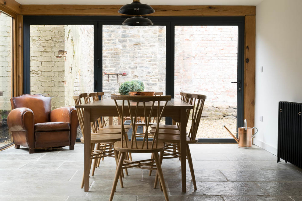 Example of a large danish limestone floor great room design in Other with white walls