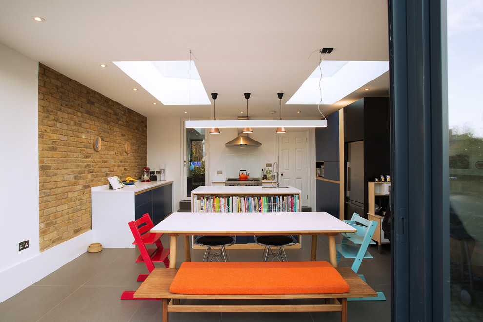 Immagine di una grande sala da pranzo aperta verso la cucina minimal con pavimento con piastrelle in ceramica, pavimento grigio e pareti bianche