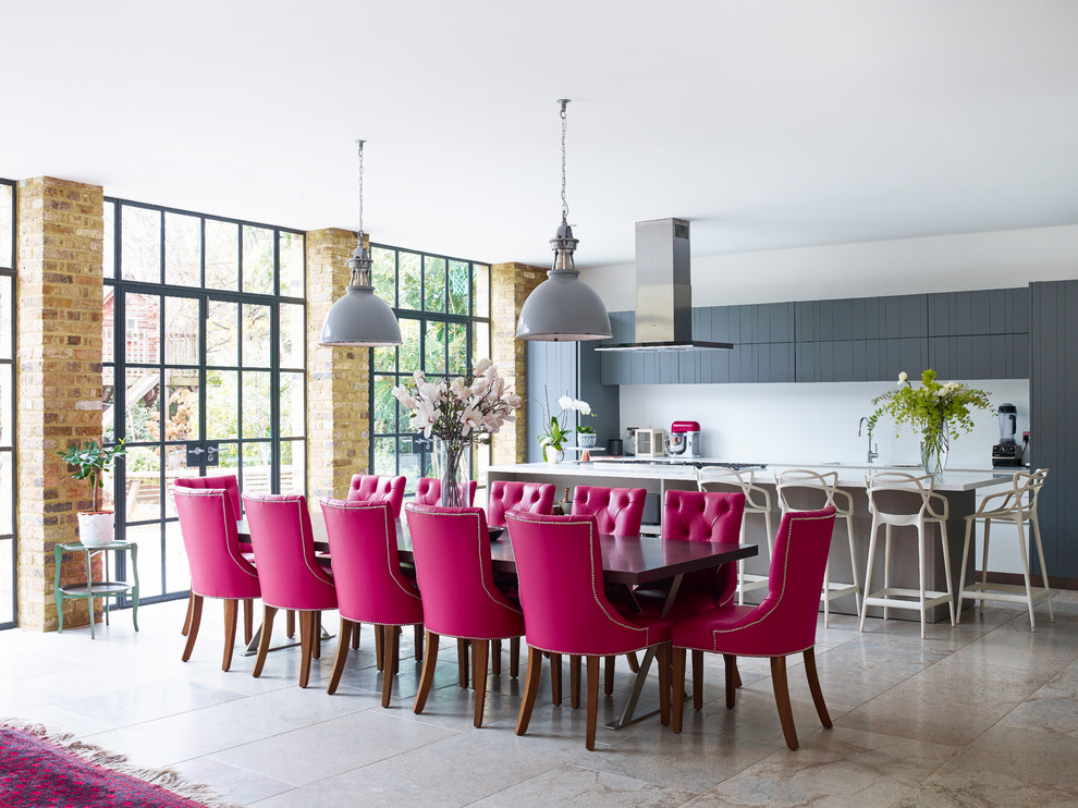 This is an example of a contemporary open plan dining room in London with white walls and beige floors.