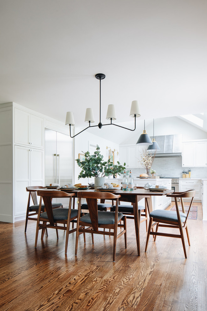 Kitchen/dining room combo - large transitional medium tone wood floor and brown floor kitchen/dining room combo idea in Chicago with white walls