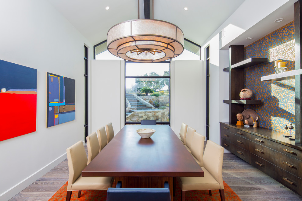Huge transitional medium tone wood floor and gray floor enclosed dining room photo in Austin with white walls