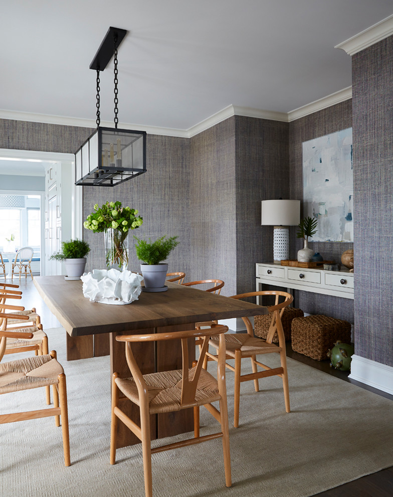 Beach style dining room in New York with feature lighting.