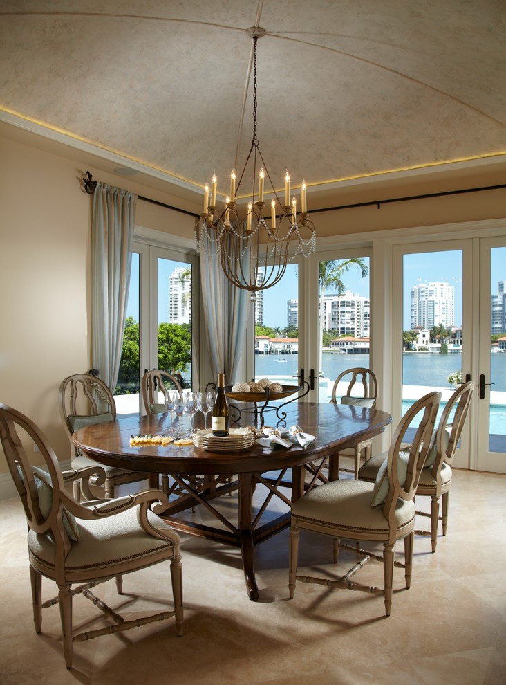 Photo of a mediterranean dining room in Miami with beige walls.