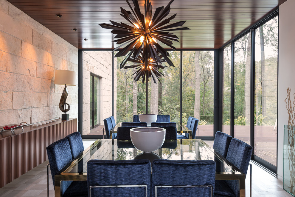 Photo of a contemporary dining room in Houston with white walls and feature lighting.