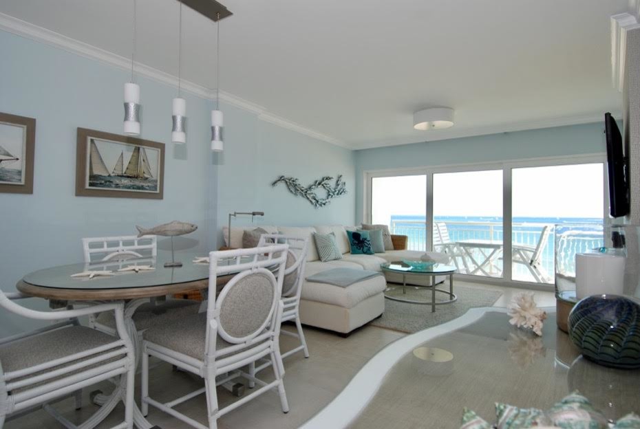 Example of a mid-sized beach style porcelain tile and beige floor enclosed dining room design in Miami with blue walls and no fireplace