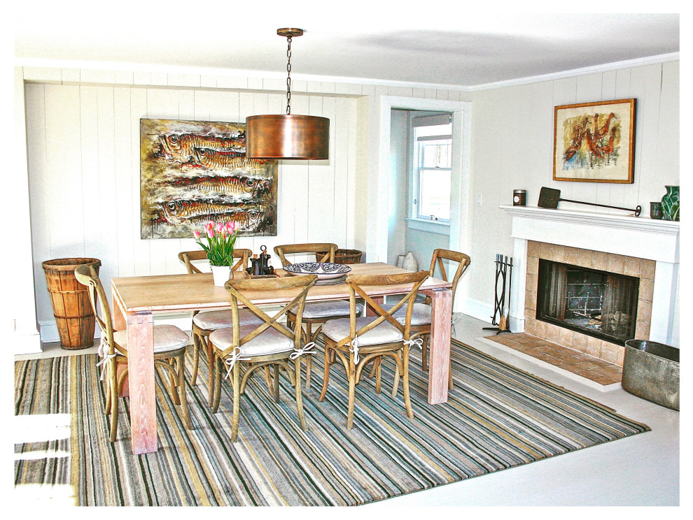 Aménagement d'une salle à manger ouverte sur le salon bord de mer de taille moyenne avec un mur blanc, parquet peint, une cheminée standard, un manteau de cheminée en carrelage, un sol gris et du lambris de bois.
