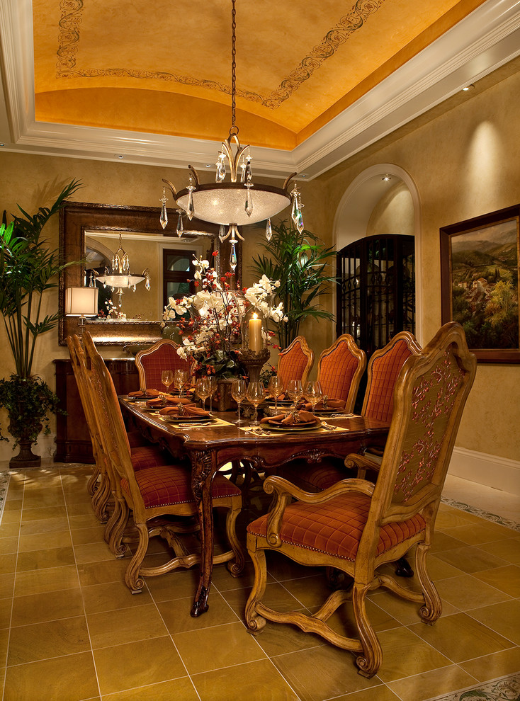Design ideas for a mediterranean dining room in Miami with yellow walls, ceramic flooring and feature lighting.