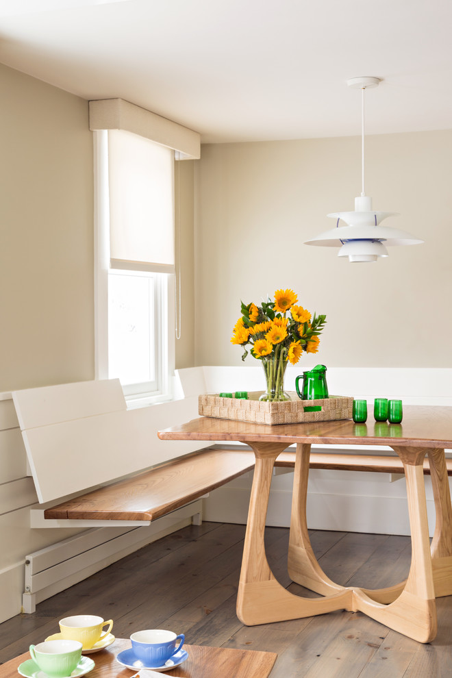 Medium sized beach style kitchen/dining room in Boston with beige walls and dark hardwood flooring.