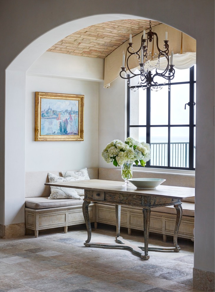 Photo of a mediterranean dining room in Orange County with white walls.