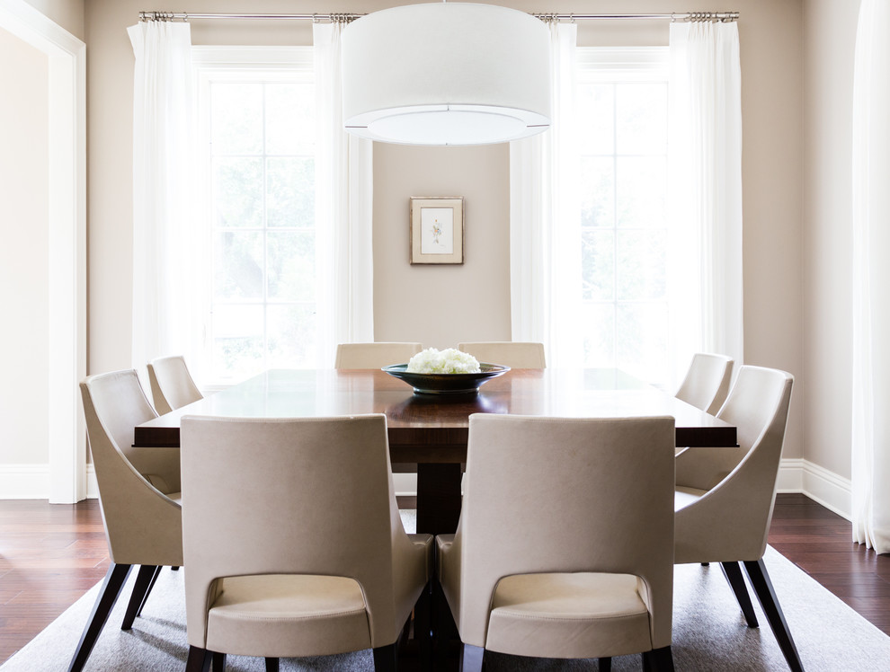 Traditional enclosed dining room in Tampa with beige walls and dark hardwood flooring.