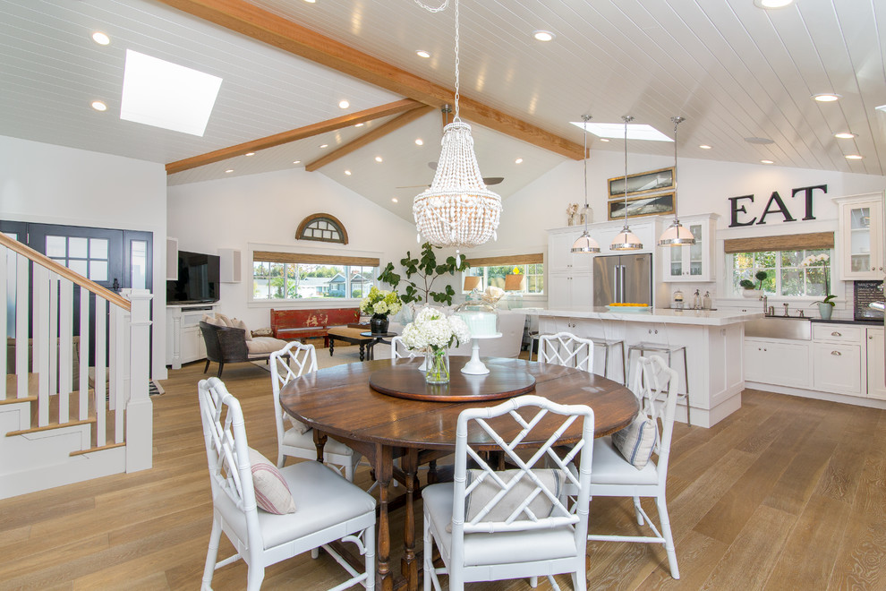 Inspiration for a coastal medium tone wood floor great room remodel in Other with white walls