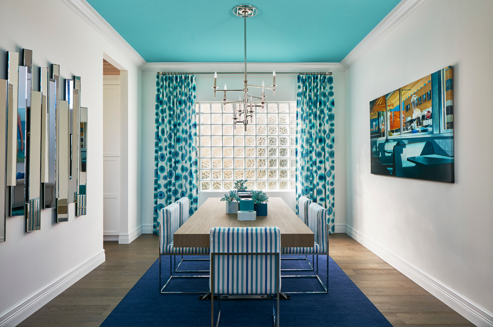 Inspiration for a large coastal enclosed dining room in Miami with light hardwood flooring and white walls.